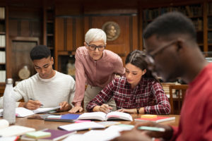 Law students working with professor on legal education topics