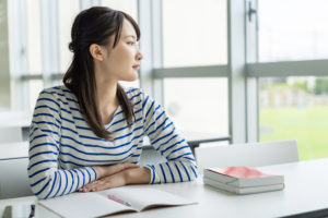 Asian female student studying in classroom.