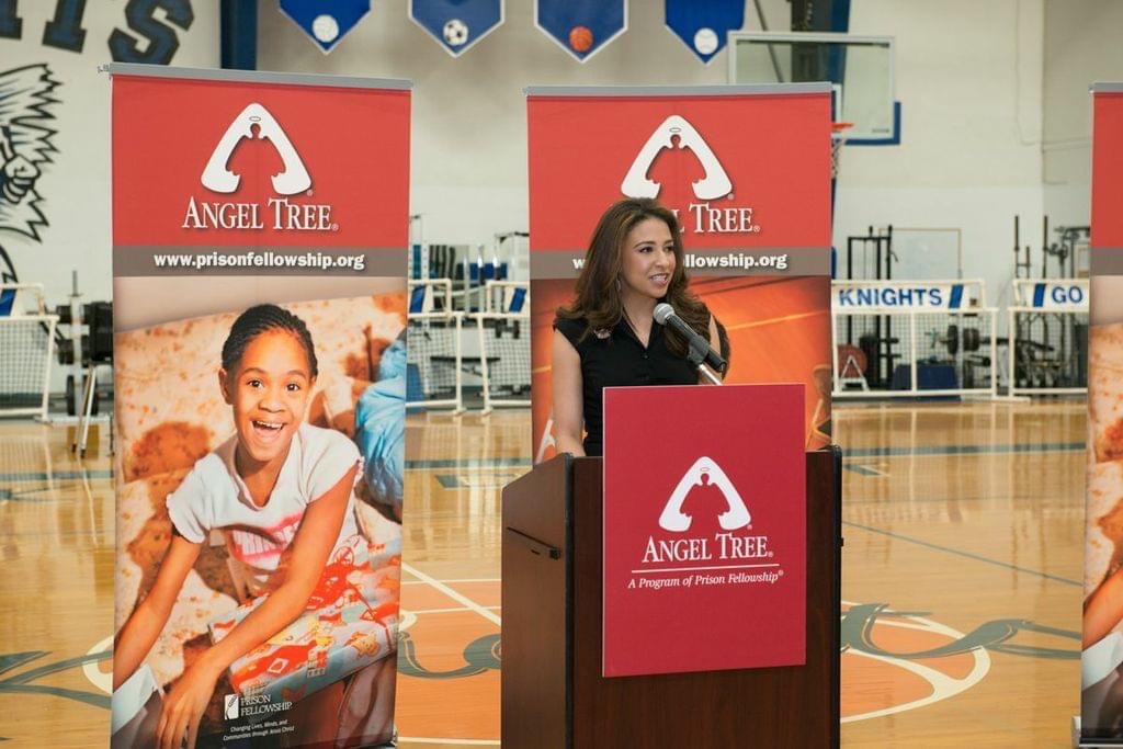 Erika Harold speaking at a podium.