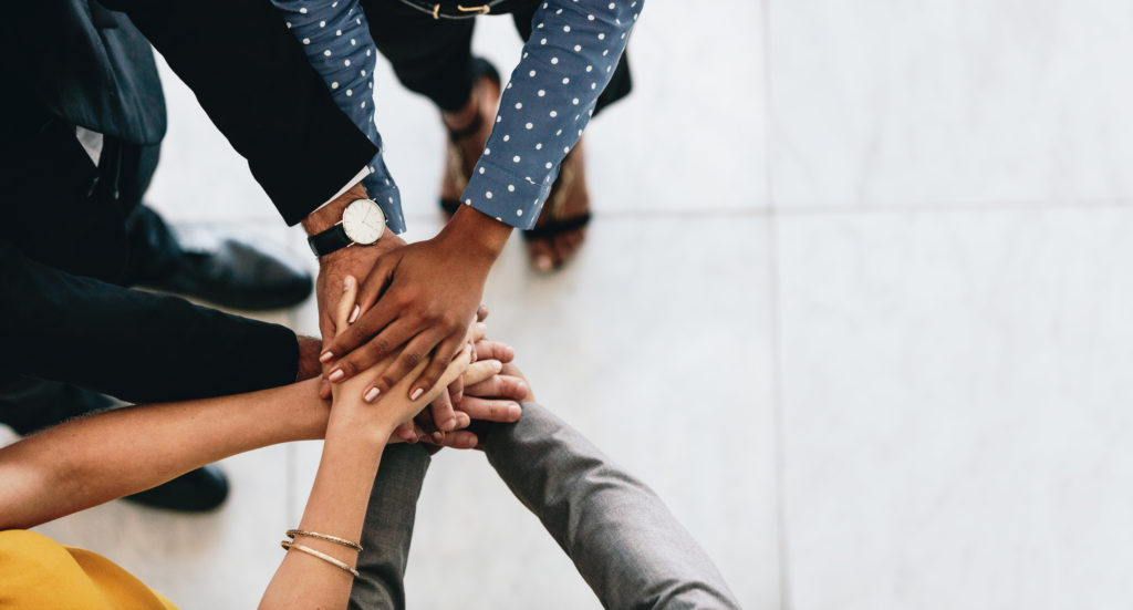 Pro bono lawyers with their hands in