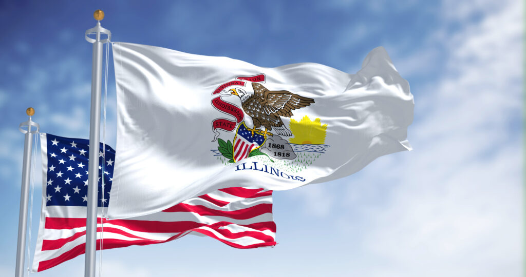 illinois law schools, The Illinois state flag waving along with the national flag of the United States of America. In the background there is a clear sky. Illinois is a state in the Midwestern region of the United States