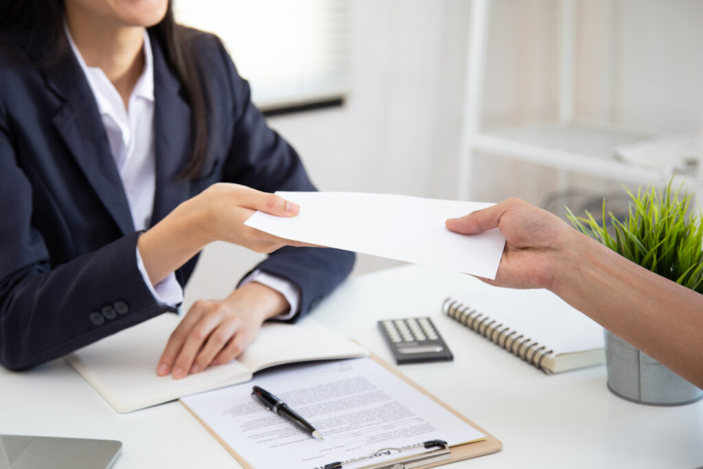 illinois supreme court compensation Close up view of Young Asian business woman receiving salary or bonus money from boss or manager at office happily