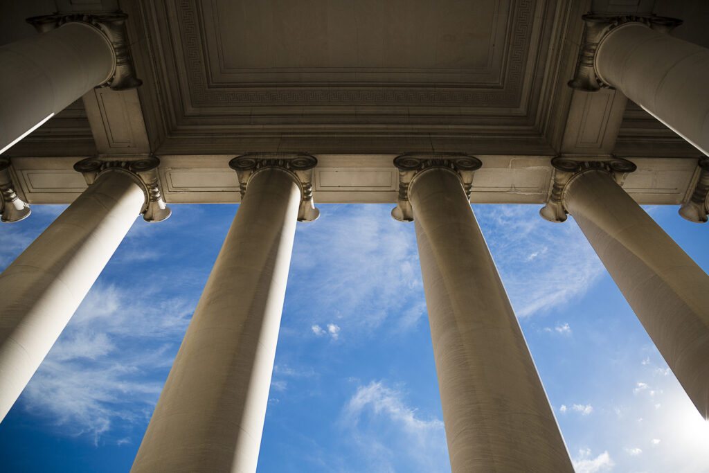 public confidence in state courts, Building column on a government building with a beautiful blue sky.