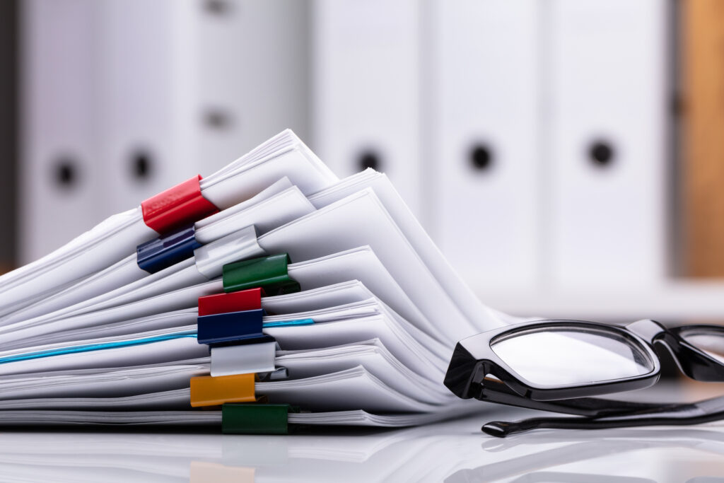 state court caseloads, Stacked Documents With Colorful Paperclips And Eyeglasses