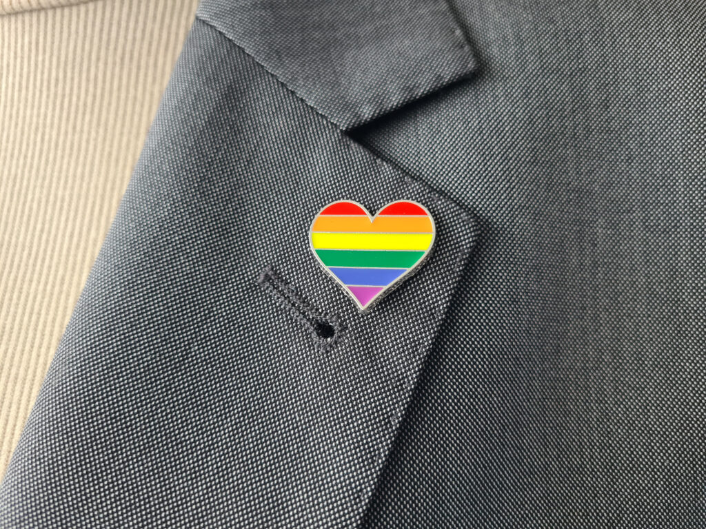 lgbtq+ lawyers allyship, Closeup of LGBT flag pin attached to business suit. LGBT rights concept