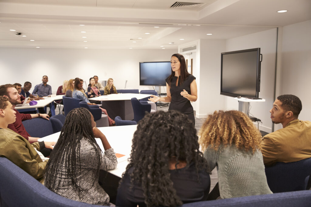 ai in law school, Female teacher addressing university students in a classroom