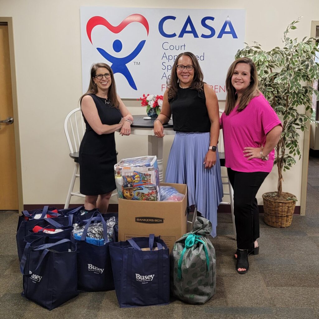Livingston with Busey Bank representatives at the Illinois CASA offices
