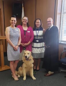 Julia Roundtree Livingston with Judge Thomas E. Little (Ret.), Jennifer Dahn, Sharon Renfro, and Remy the Courthouse Facility Dog Illinois CASA