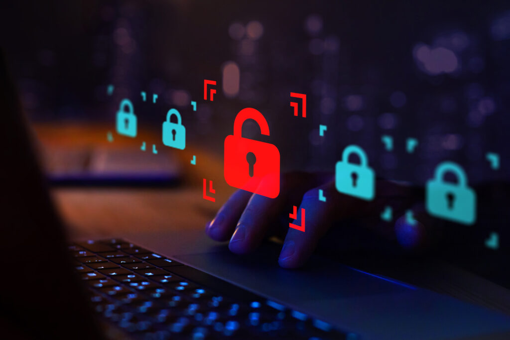 image depicting a hacker attack or security breach on the internet using multicolored locks, a computer keyboard, and someone's hand