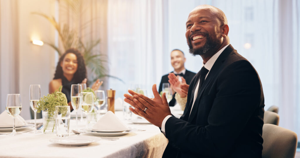 illinois legal events 2025, Applause, champagne and man at party for celebration, social event and gathering. Glass, luxury and men and women with liquor for cheers, toast and speech at gala, new years eve and business dinner